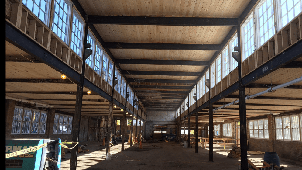 Renovation of historic warehouse showing interior construction progress.